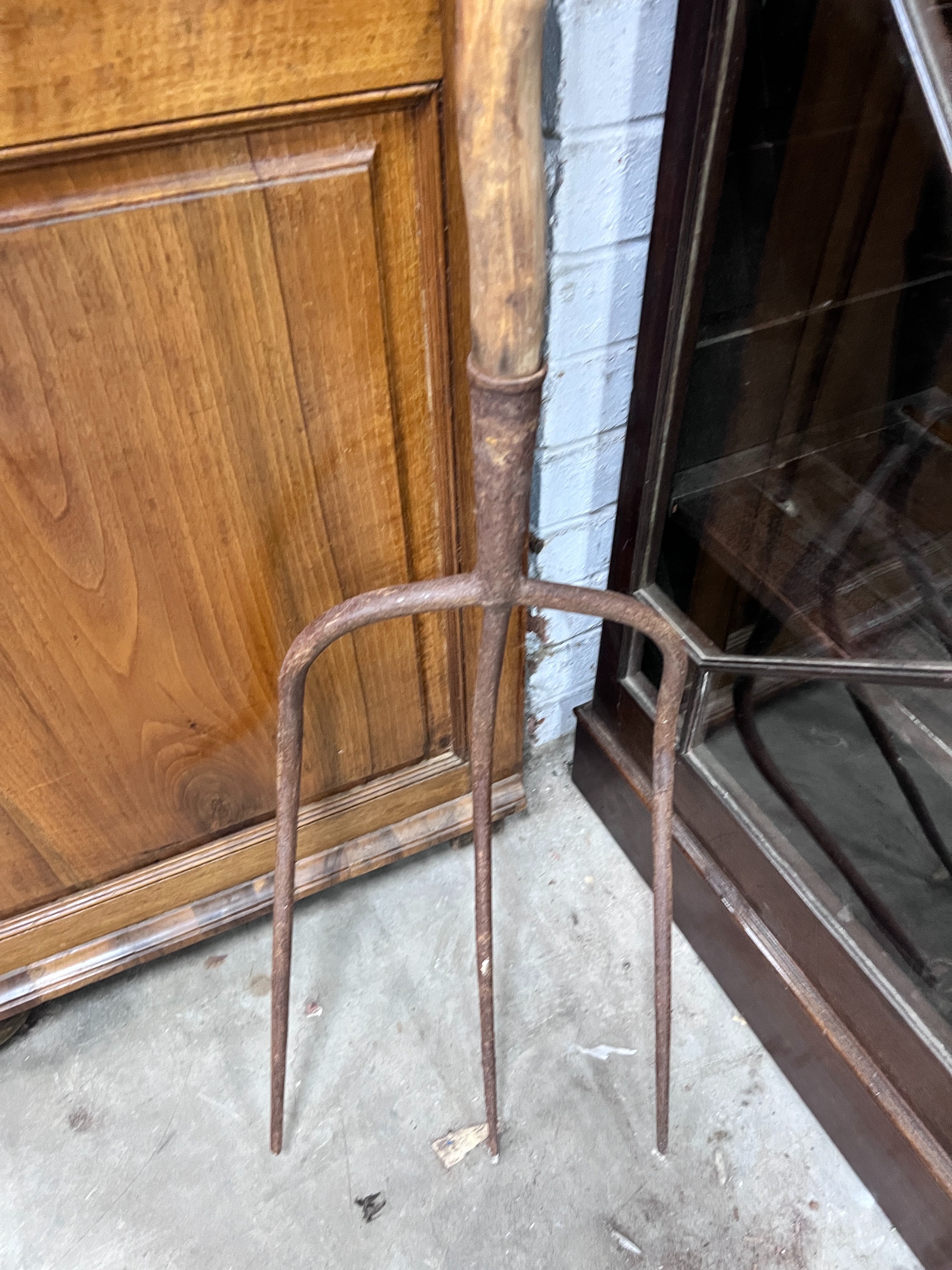 A provincial wrought iron and wood pitchfork, length 175cm *Please note the sale commences at 9am.